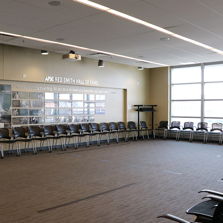 Empty meeting room with chairs around the sides of the room.
